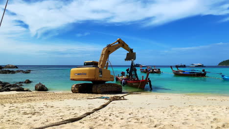a shot of an excavator with men working by the beach.