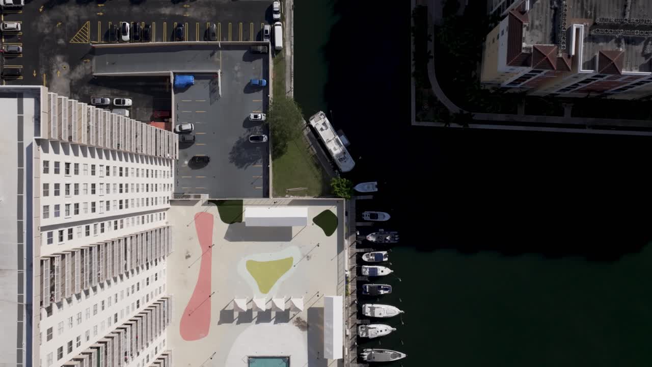 Top-Down Aerial View of Pedestrian Bridge and Waterfront Buildings in Sunny Isles Beach, Florida