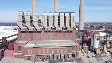 Abandoned-coal-powered-plant-with-tall-chimneys,-aerial-drone-view