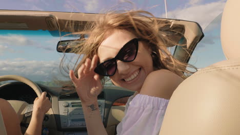 happy women enjoying a road trip in a convertible