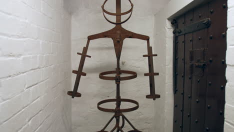 a medieval middles ages torture chamber in a dungeon prison cell with an iron man