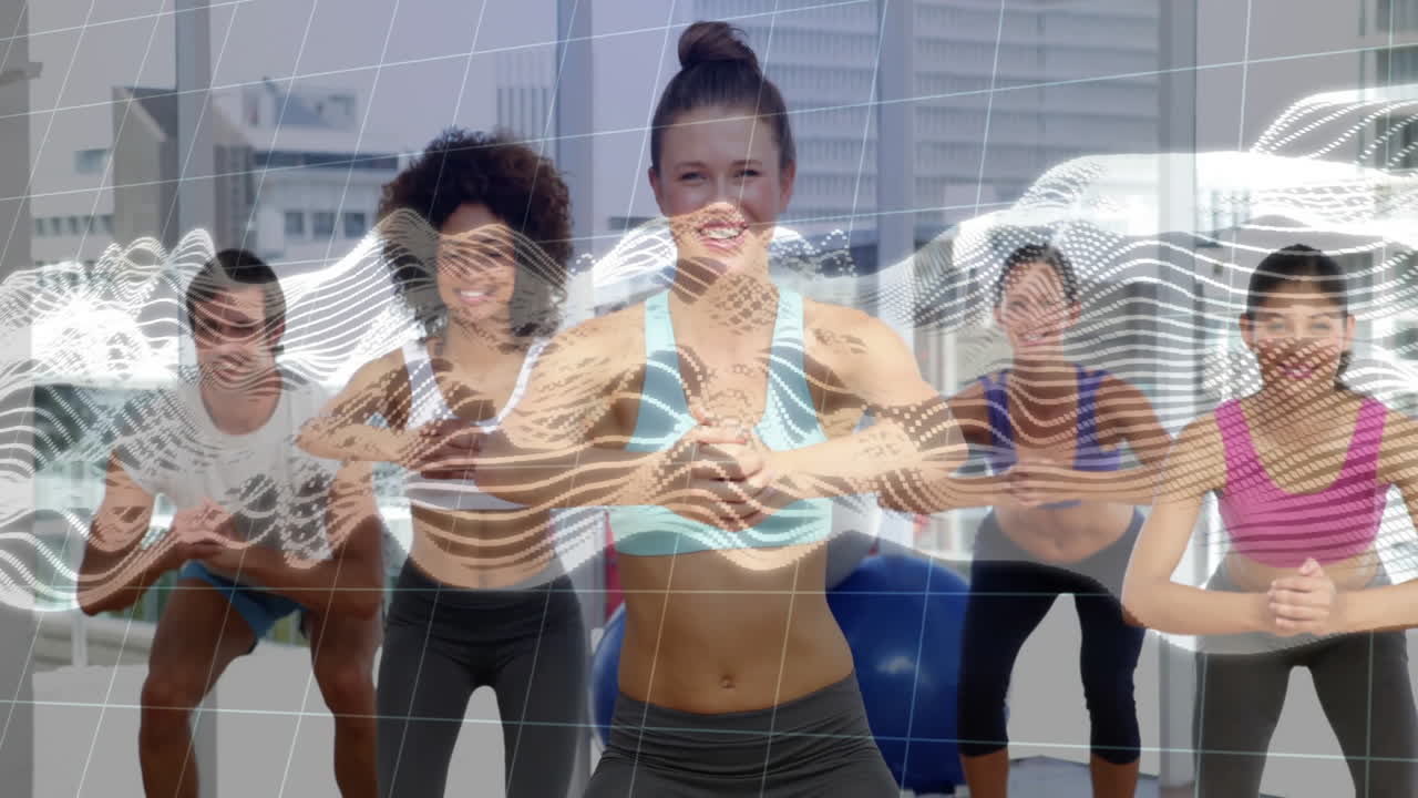group performing squats in modern fitness studio with exercise ball, digital wave overlay