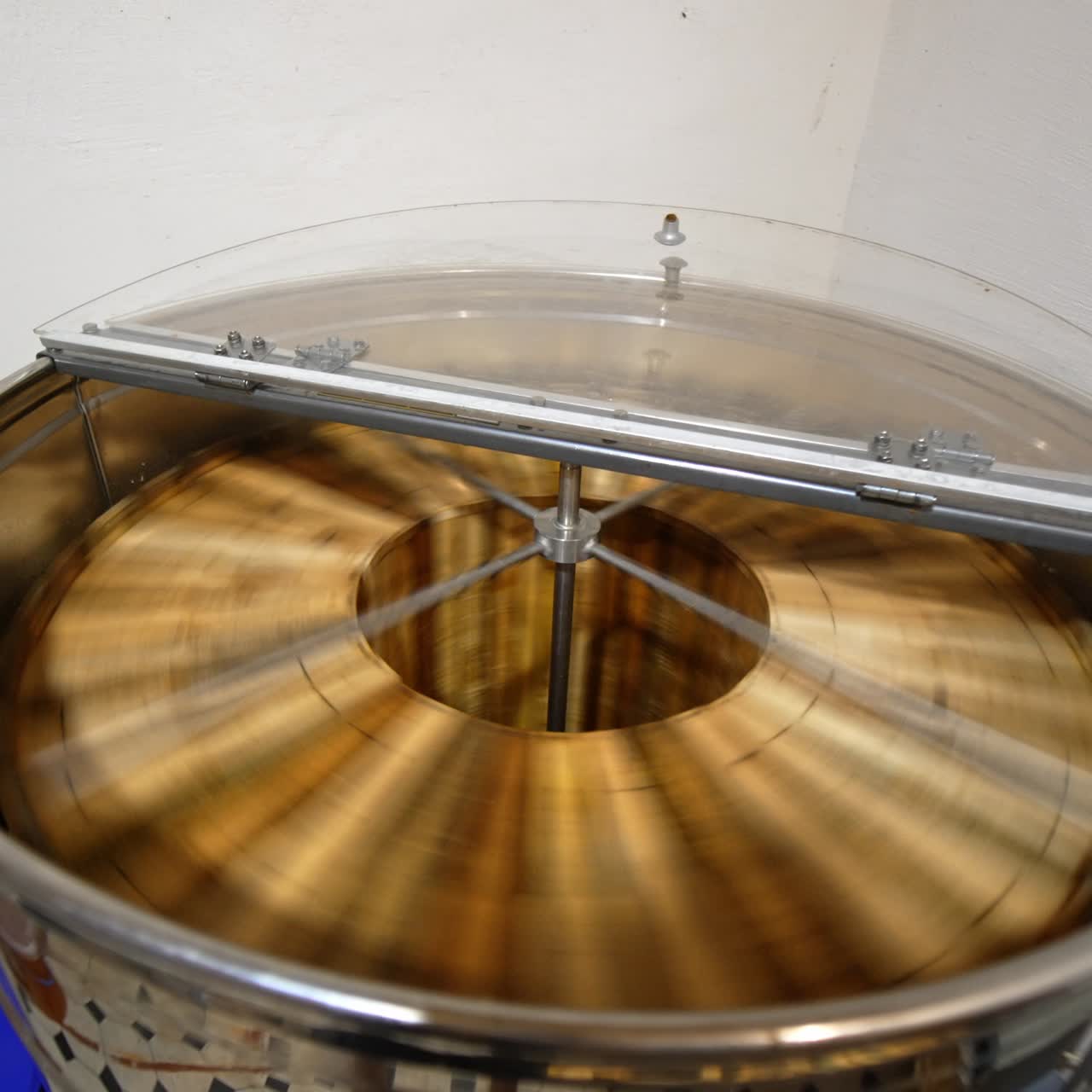 Electric machine for honey extraction working in the apiary. Device for harvesting fresh organic product at modern bee farm