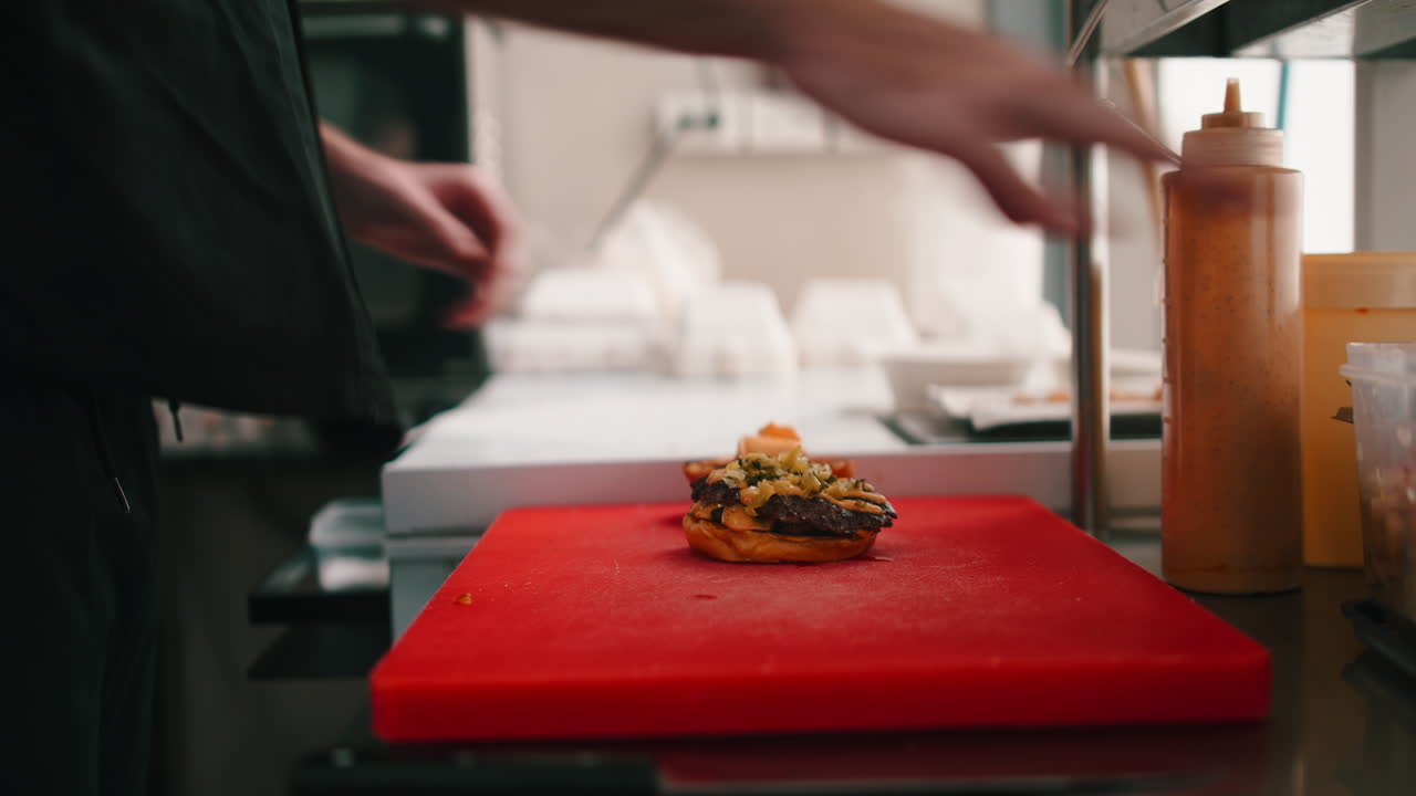Burger being prepared in a kitchen