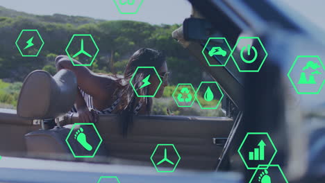 woman applying lipstick while viewing green hexagon energy icons over convertible on rural road