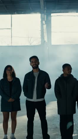 group of five standing in abandoned warehouse with natural light