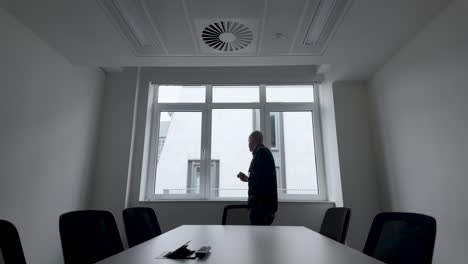 Lone-Person-Pacing-Up-and-Down-In-Meeting-Room-In-Office