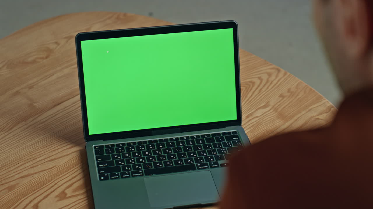 Business man looking green screen laptop waiting online in cafe table closeup