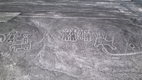 aerial panorama view of mysterious humnoid creatures in the peruvian desert in nazca