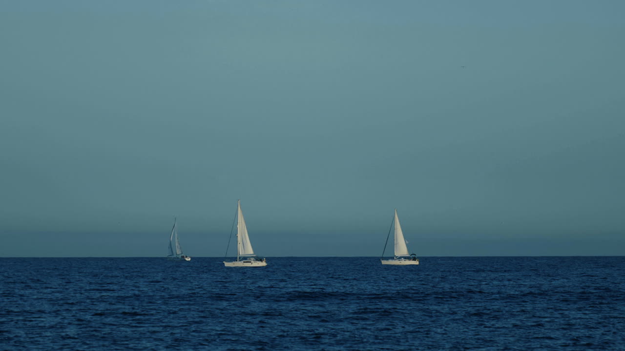 Sailboats on a Calm Ocean at Dusk