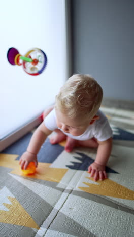 little cute boy sitting and playing indoor. small baby educational play. vertical video.