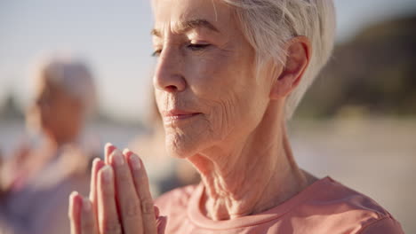 Beach-yoga-class,-face-or-senior-woman-doing