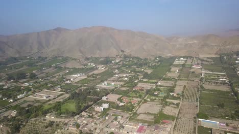 stunning aerial shot of azpitia valley, showcasing green farmland, rugged mountains, and rural charm. ideal for travel, editorial, or real estate use. azpitia, peru.