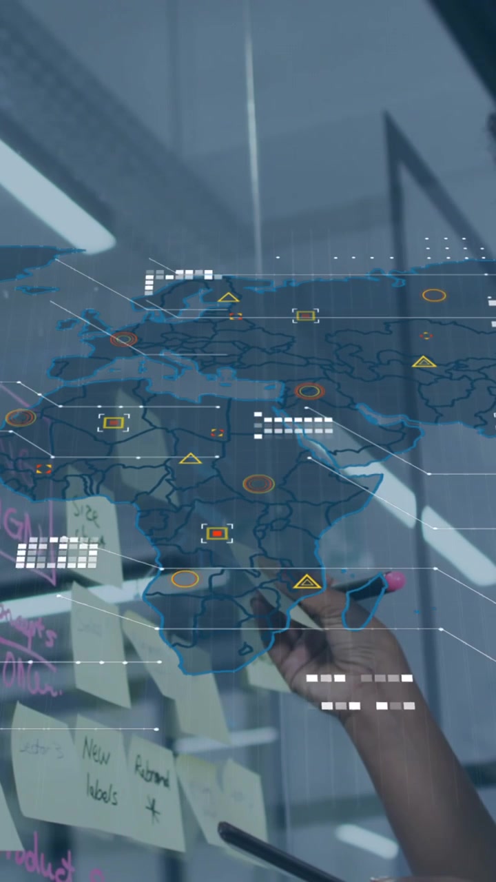 Animation of world map over african american woman sticking memo notes on glass board at office