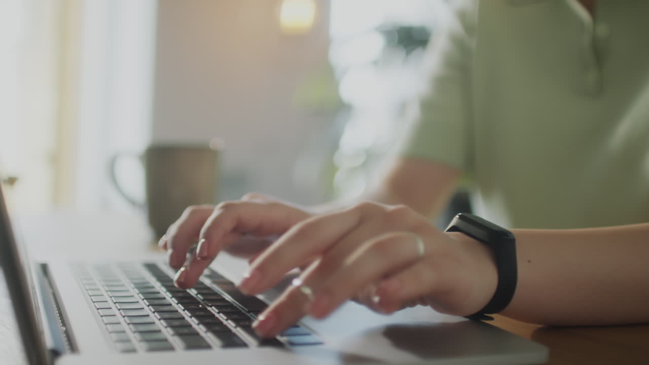 Hands of Woman Typing on Laptop at Desk