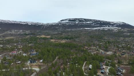 mountain recreational homes in bjorli highlands norway - summer aerial with snow patches left in mountain background