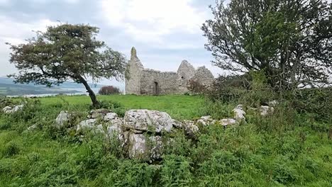 The-stone-ruins-of-Capel-Lligwy-on-rural-Moelfre-countryside,-Anglesey,-North-Wales