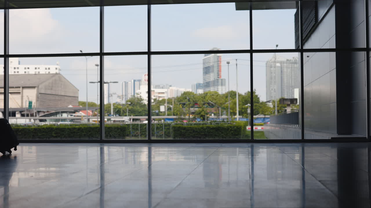 Silhouette of a woman with luggage in an airport terminal