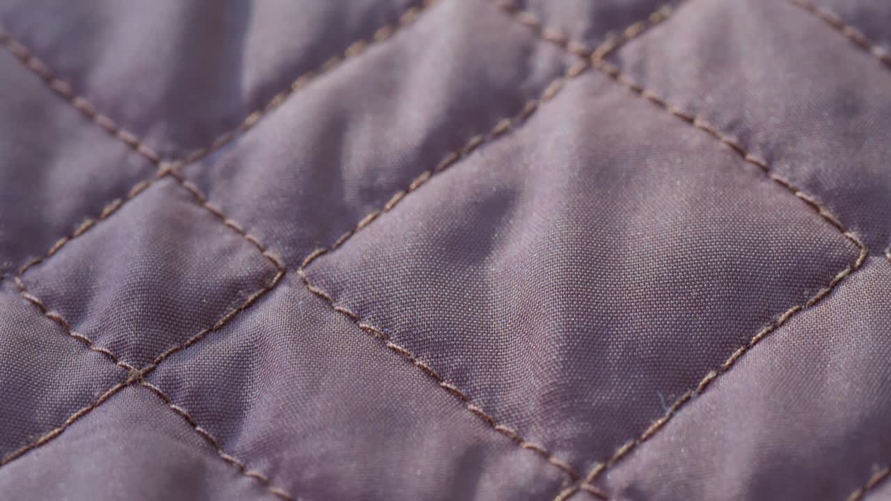 Close-up of Quilted Fabric with Diamond Stitching Pattern