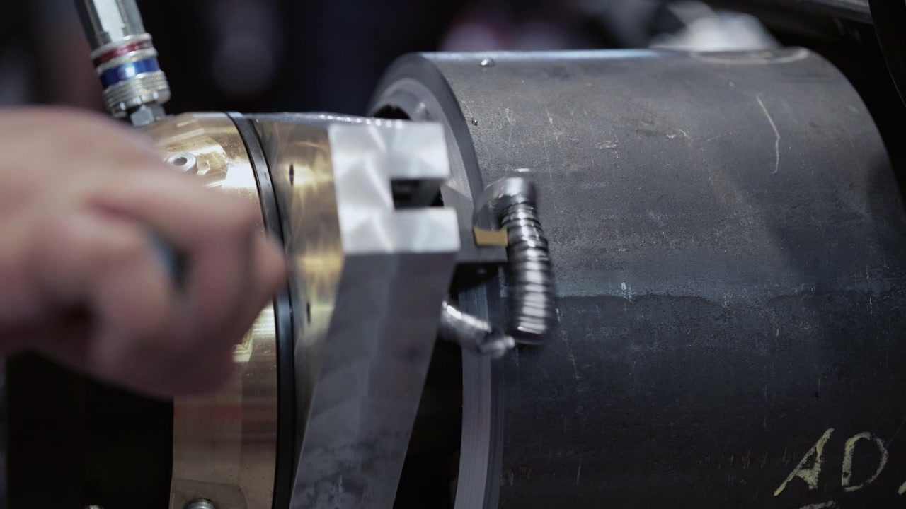 Industrial Lathe Machine Cutting Metal Part in Workshop