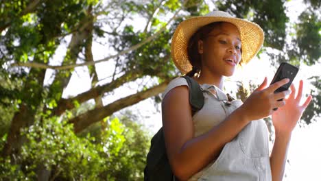 female hiker using mobile phone at countryside 4k