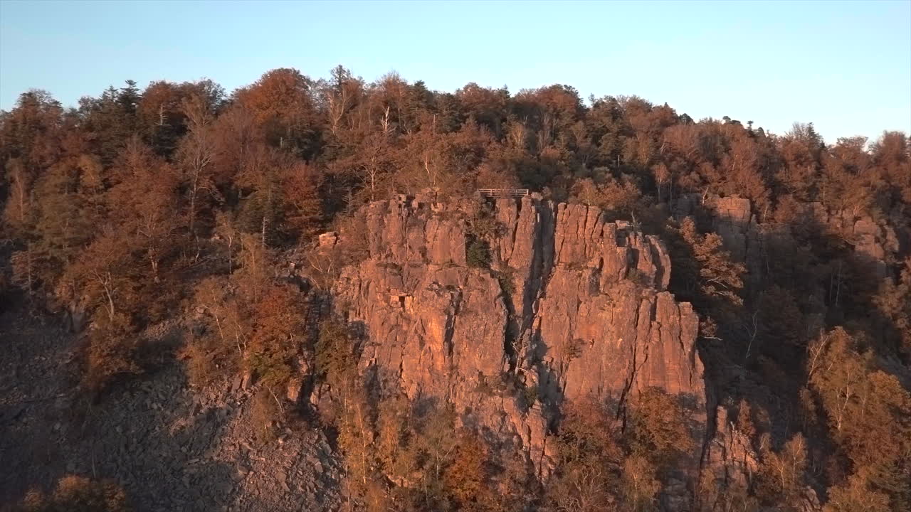 Rotating pan from of the rock formation Battert above the spa town of Baden-Baden revealing the valley in autum at golden hour