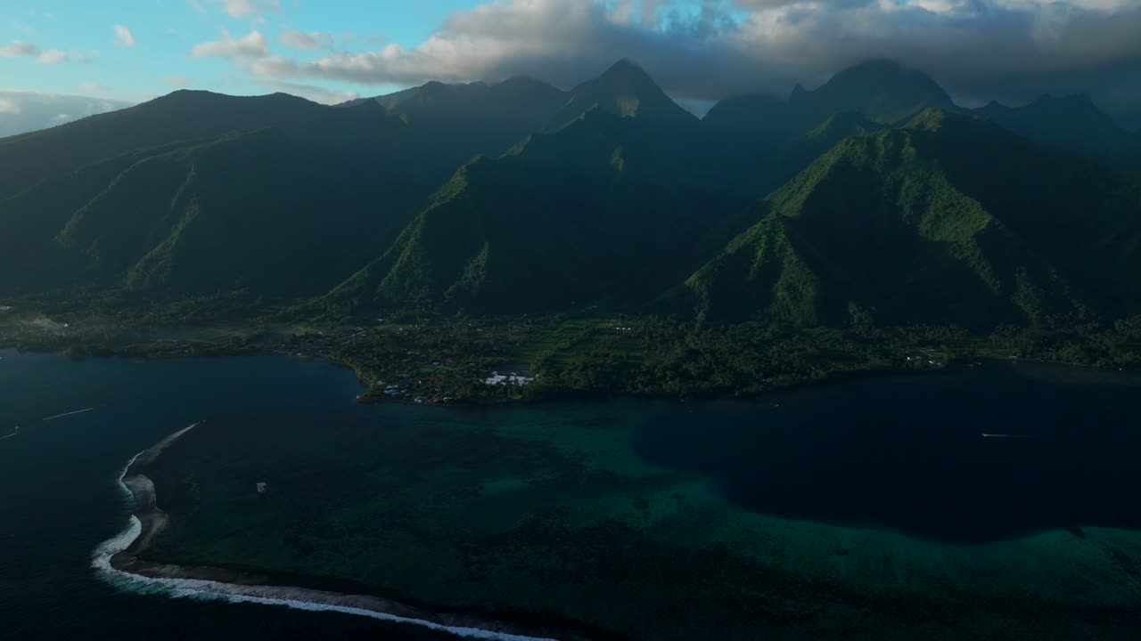 Last light sunset on towering mountain peaks surf reef break channel Teahupoo Wave Tahiti French Polynesia aerial drone view incredible stunning island landscape Moorea Bora Bora Papeete circle right