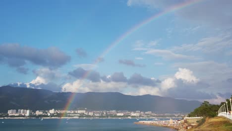 rainbow over a coastal city