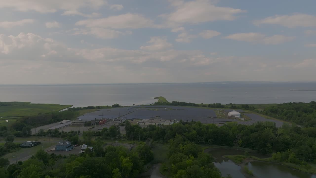 Beautiful 4K aerial drone footage showing a sweeping coastline bay with clear water and natural landscape, ideal for travel, tourism, or nature visuals