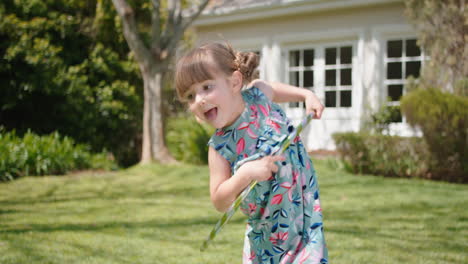 little girl playing with hula hoop toy happy child playing game having fun outdoors in sunny backyard garden enjoying childhood 4k