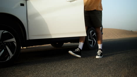 couple taking backpacks from the car