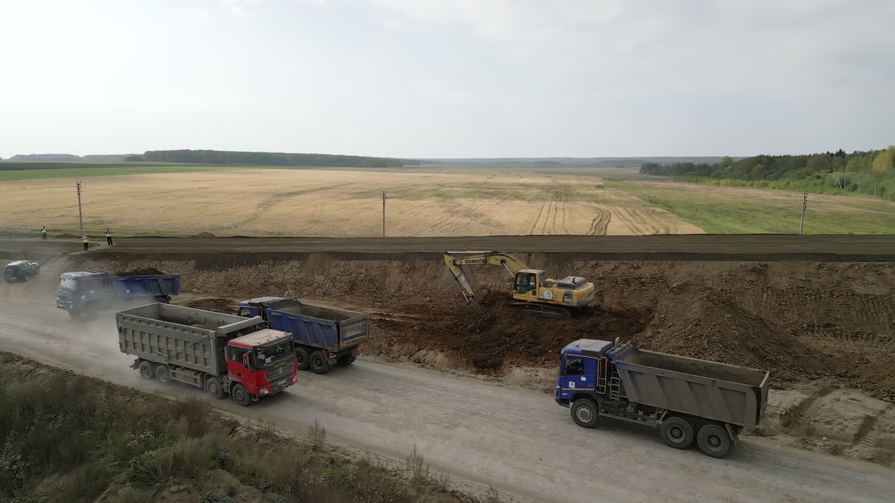 Road Construction Site with Excavator and Dump Trucks