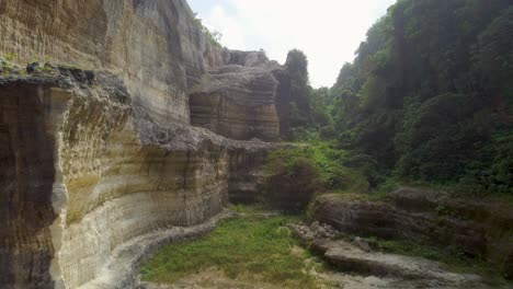 AERIAL:-Drone-shot-flying-through-a-cliff-in-Bali