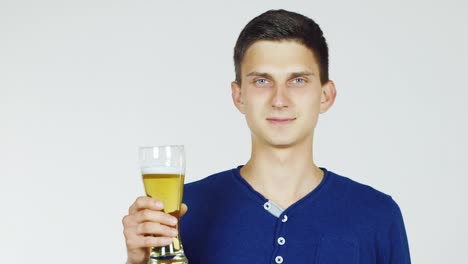 A-Young-Man-With-A-Glass-Of-Beer-On-A-White-Background-Hd-Video