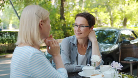 two women enjoying coffee in a cafe