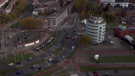 cars and public transport on a busy intersection in rotterdam, the netherlands