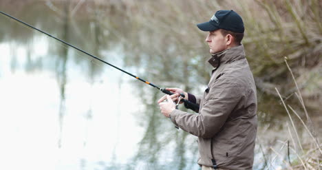 Fisherman-Holding-Fishing-Rod-In-Hands-1