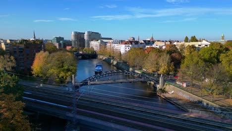 beautiful autumn day in berlin: canal, bridge and cityscape