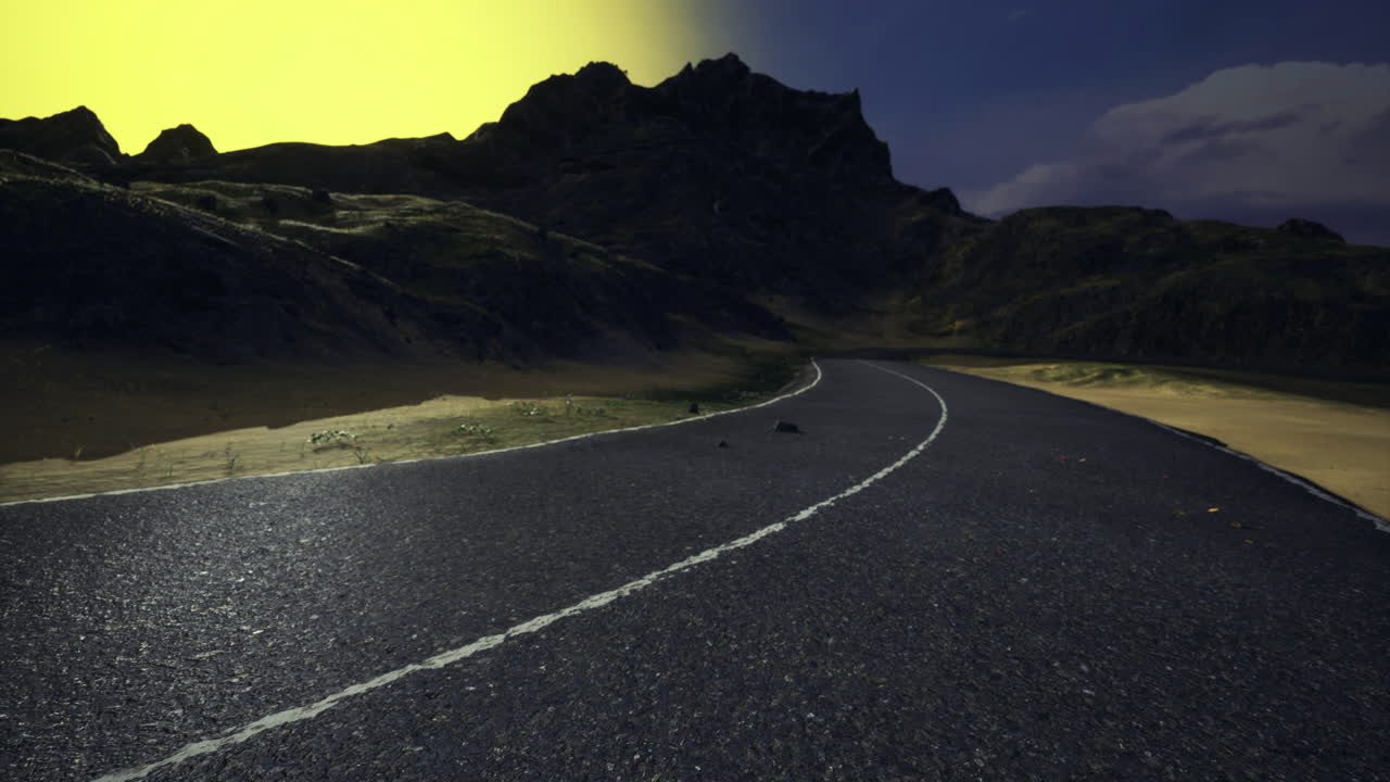Winding road surrounded by mountains at sunset near a tranquil valley