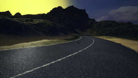 winding road surrounded by mountains at sunset near a tranquil valley