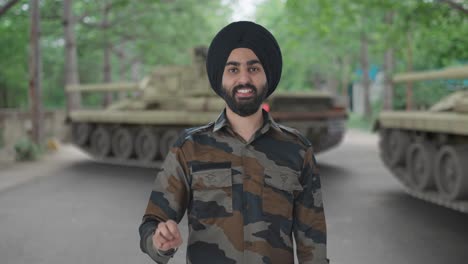 happy sikh indian army man showing victory sign