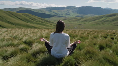 woman meditating in a mountain landscape