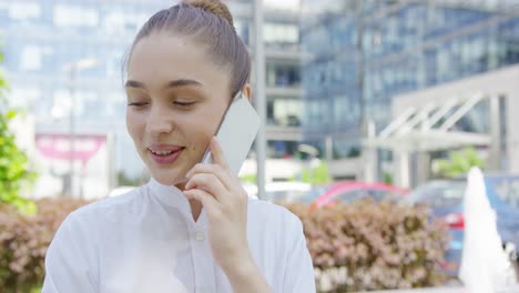 lovely girl talking phone on urban background