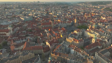 Aerial-drone-over-old-city-center-of-Prague-European-historic-buildings,-Vltava-Elbe-River,-old-town-square-Staroměstské-náměstí,-astronomical-clock,-cathedral-and-hills