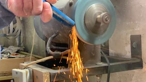 grinding metal rod on a metal grinding machine in super slow motion