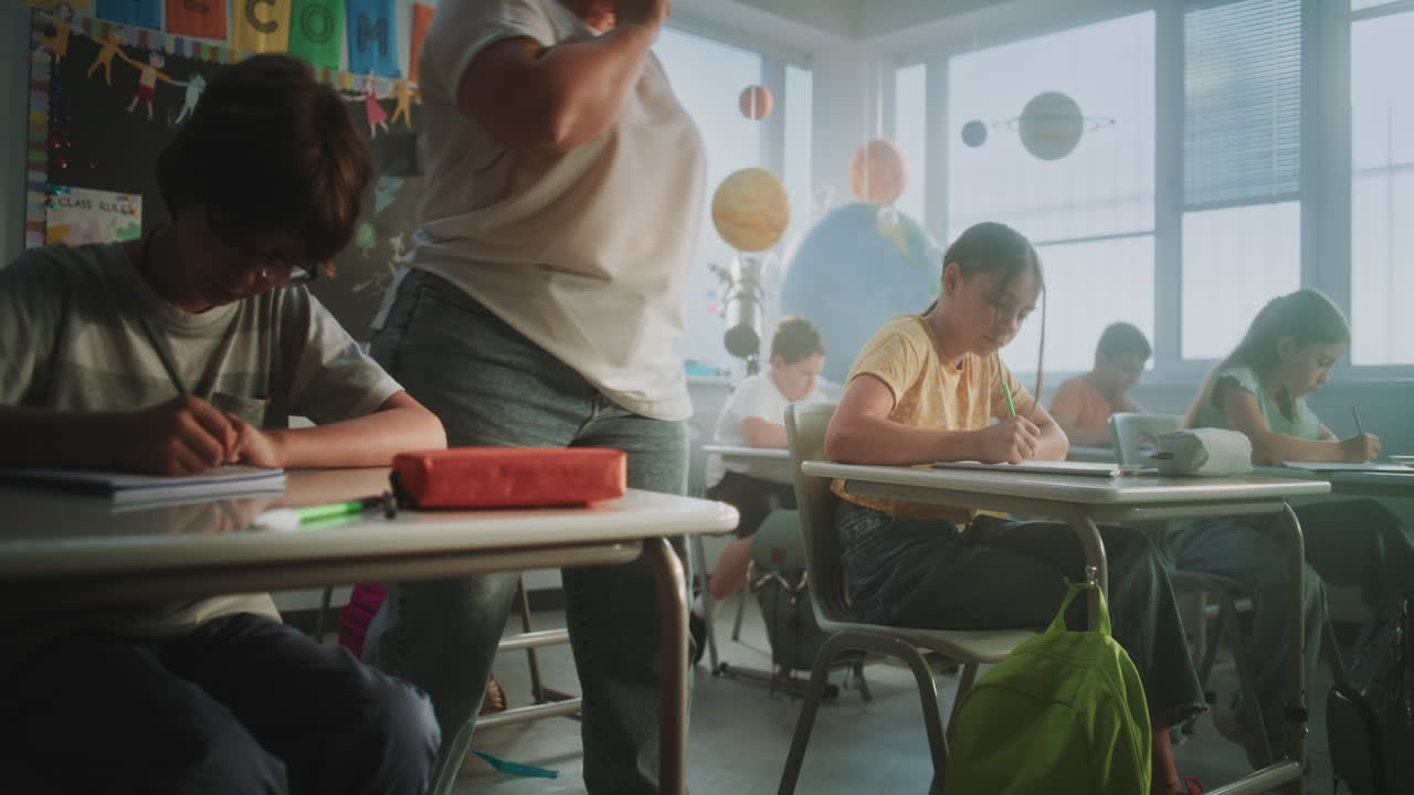 Elementary School Students Sitting at Desks Studying in Modern Classroom