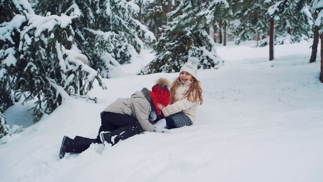 smiling children playing on snow in winter holiday