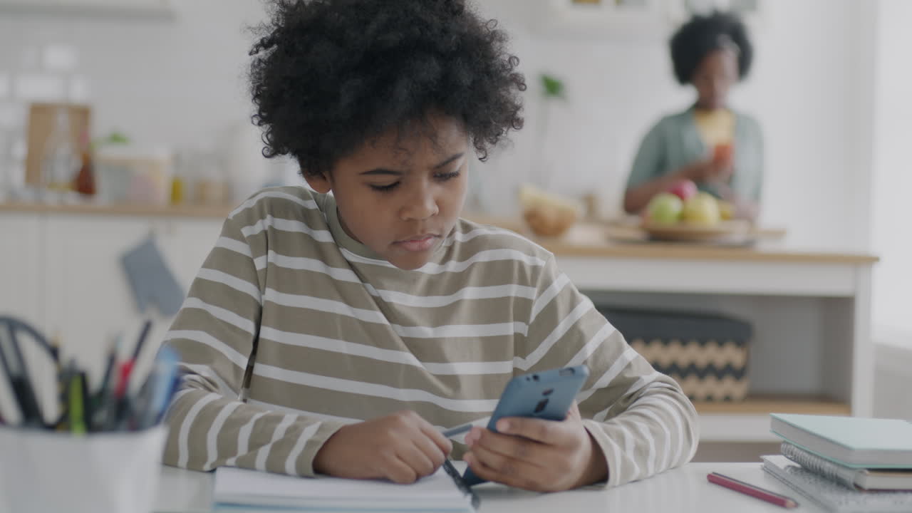 Child doing homework at the kitchen table