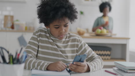 child doing homework at the kitchen table