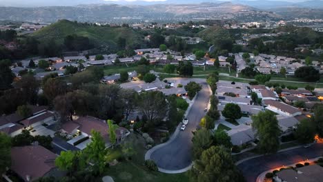 aerial view flying over santa clarita wealthy city suburb neighbourhood during sunset